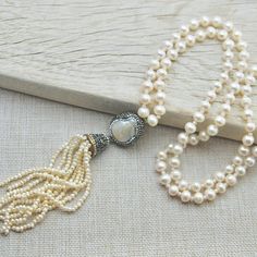 "This baroque pearl necklace is a stylish combination of natural pearls, swarovski crytals and sterling silver. Drop shaped pendant of this bridal necklace is decorated with swarovski crystals and sterling silver has been used as foundation. Length of this wedding jewelry is 24\" so you can also use this boho necklace as a stylish necklace This pearl necklace also makes a perfect gift for brides, bridesmaids and wives. You can wear this unique necklace with your night dresses for special nights. Wedding Jewelry: Long Pearl Charm Necklace, Long Pearl Charm Necklace For Weddings, Pearl Charm Long Necklace For Wedding, Wedding Long Necklace With Pearl Charm, Wedding Long Baroque Pearl Necklace, Baroque Pearl Pendant Jewelry For Wedding, Pearl White Baroque Pearl Necklace For Wedding, Wedding Long Necklace With Pearl Pendant, Silver Pearl Drop Necklace For Mother Of The Bride