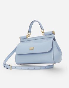 Medium Sicily handbag in polished calfskin: Light blue Front flap with hidden double magnetic fastening Branded tag featuring two metal plating finishes Top handle and adjustable, detachable strap in polished calfskin Printed fabric lining and flat pocket Item comes with a branded dust bag Measurements: H17 x W25 x D9 cm Made in Italy Dolce And Gabbana Light Blue, Trendy Handbags, Bag Measurements, Brand Tags, Printed Fabric, Top 100, Sicily, Blue Leather, Top Handle