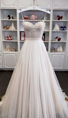 a white wedding dress on display in a store