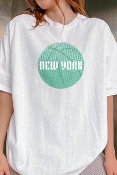 Show your New York basketball pride with our Liberty T-Shirt! This Women's Sports Fans Tee is perfect for any dedicated supporter. This shirt makes a great gift for any New York Liberty or WNBA fan. Wear it to games, events, or just around town to celebrate women's sports in New York. Whether you're cheering at the arena or watching from home, this New York Basketball Shirt is a must-have for every fan. Get yours today and support your favorite WNBA team with pride! If you're looking for a thick Sports Tops With Screen Print In Relaxed Fit, Relaxed Fit Sports Tops With Screen Print, Green Relaxed Fit Tops For Sports Events, Athleisure T-shirt For Sports Events, Sports Tops With Relaxed Fit And Screen Print, Sports Season Tops With Text Print For Sports Events, Sports Event Tops With Text Print, Basic Graphic Print T-shirt For Sports, Text Print Tops For Sports Events