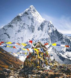 the mountain is covered in many colorful flags