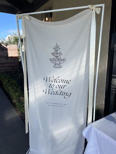 a welcome to our wedding banner hanging outside