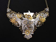 A gorgeous, eye-catching, metal alloy necklace in bronze, silver and gold tones that would make a wonderful gift for any admirer of stylish Steampunk fashion. A hand-crafted bronze metal alloy filigree base is topped with a stunning central silver filigree owl with rhinestone diamante crystal eyes, and a chest that is a genuine clockwork watch mechanism.  The owl is wearing a Mad Hatter-style Steampunk top hat that bears an inscription derived from Alice in Wonderland: "Your mad - I'm mad - We'r Steampunk Clockwork, Watch Mechanism, Owl Necklace Silver, Steampunk Top, Mode Steampunk, Steampunk Top Hat, Crystal Eyes, Steam Punk Jewelry, Style Steampunk