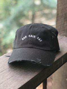 We all have em Swap the dry shampoo for this cute and stylish slightly distressed black dad hat embroidered with white thread Hat is adjustable on the back with a fabric strap One size fits most Men Shampoo, Caps Ideas, Black Dad Hat, Bad Hair Day Hat, Edgy Fashion Chic, Tee Ideas, Store Design Boutique, Tshirt Printing, Tshirt Printing Design