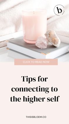 a pink candle sitting on top of a book