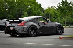 a black sports car parked in a parking lot