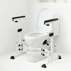 a white toilet sitting in a bathroom next to a black and white wall mounted rack