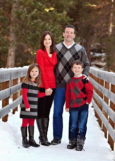 a family standing on a bridge in the snow