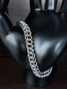 This lightweight chainmaille bracelet is perfect as a charm bracelet, or can be worn alone for singular style. It utilizes the Half Persian 3-in-1 weave and stainless steel construction to provide strength and durability. With minimal care, it could easily last a lifetime! Every ring is hand woven into place. An attractive addition to your collection, and appropriate for either a man or a woman. To care for your stainless steel jewelry, clean (or sonicate) with dishsoap, or lotion-free handsoap, Stainless Steel Chainmail Bracelet As Gift, Stainless Steel Chain Link Jewelry With Jump Ring, Silver Stainless Steel Chainmail Bracelet, Silver Chainmail Stainless Steel Chain Bracelet, Chainmaille Ring, Chainmaille Jewelry Patterns, Chainmaille Tutorial, Chainmaille Bracelet, Chain Maille Jewelry