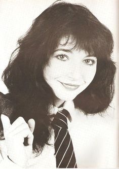 a black and white photo of a woman wearing a tie