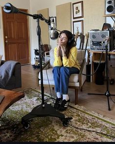 a woman sitting in a chair with headphones on