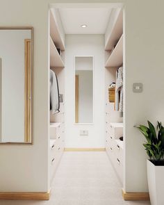 an empty walk - in closet with white walls and drawers