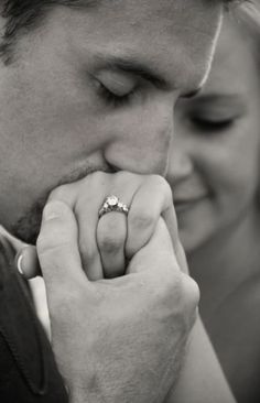 a man and woman are looking at each other with their wedding rings on their fingers