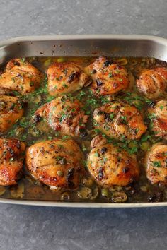 a pan filled with chicken and vegetables on top of a table