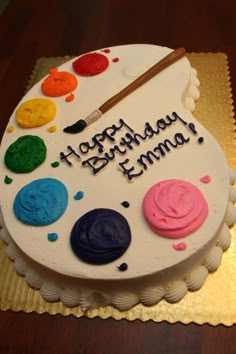 a birthday cake with paint and brushes on it