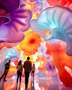 people are standing in front of colorful blown glass art installation at the muti - colored museum