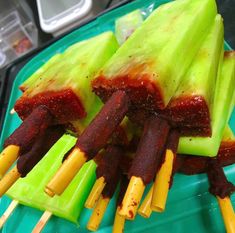 some food is on a green plate with toothpicks