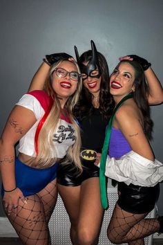 three women dressed in costumes posing for the camera