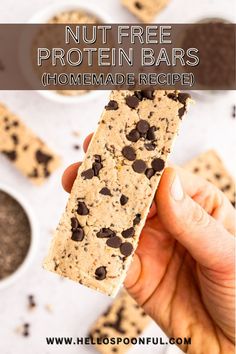 a hand holding up a cookie bar with chocolate chips on it and the text, nut free protein bars homemade recipe