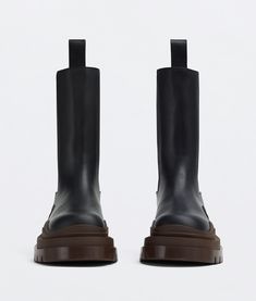 "Find BOTTEGA VENETA Tire Chelsea Boot on Editorialist. Vegetally-tanned leather Chelsea boots. Lining: Calfskin. Color: Black/Ebony. Rubber outsole. Flatform: 5.5 cm | 2.2\". We recommend to take half a size down. • Material: Calfskin." Black Calf Leather Platform Boots With Rubber Sole, Black High Ankle Chelsea Boots In Calf Leather, Black Calf Leather Platform Boots, Black Calf Leather Platform Boots With Leather Lining, Black Calf Leather Heeled Boots With Rubber Sole, Designer Leather Platform Boots With Lug Sole, Black Calf Leather Boots With Leather Footbed, Black Leather Platform Boots With Leather Sole, Designer Leather Platform Boots For Fall