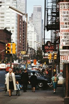 people are walking down the street in new york city