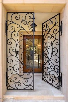 an ornate iron gate is open to the outside