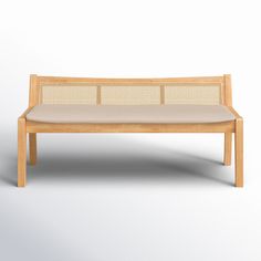 a wooden bench sitting on top of a white floor next to a light colored wall