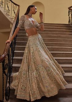 Dive into a world of ethereal beauty with this exquisite ivory raw silk lehenga set. It's adorned with a mesmerizing array of multi-colored hues of resham embroidery, complemented by the shimmer of sequin, the intricacy of zardosi, and the sparkle of mirror work. Each detail captures the essence of elegance and charm, making every moment a celebration of timeless sophistication and style. Embroidery Lengha, Saree Farewell, Lehenga Designs Latest, Wedding Lengha, Punjabi Girl, Indian Bridesmaids, Resham Embroidery