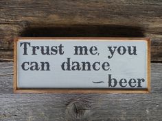 a wooden sign that says trust me you can dance beer on the side of a wall