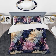 a bed with flowers on it and a mirror in the corner next to two nightstands