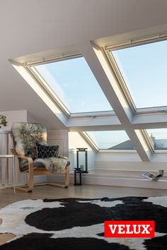 a room with two skylights and a chair