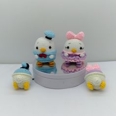 three crocheted stuffed animals sitting on top of a white table next to each other