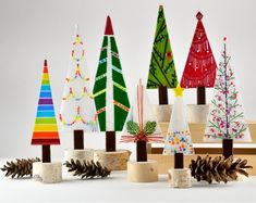 a group of small wooden trees sitting next to each other on top of a table