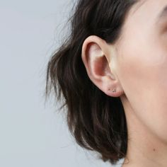 a close up of a woman's ear wearing an earring with the word love written on it