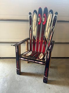 a chair made out of skis sitting in front of a garage door