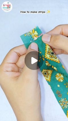 someone is making a tie with green and yellow designs