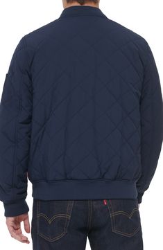 This quilted bomber jacket with ribbed banding at the collar, cuffs and hem will be your go-to when the weather turns. 26" length (size Medium) Blade collar 89% polyester, 11% spandex Machine wash, tumble dry Imported Casual Nylon Outerwear With Elastic Cuffs, Casual Quilted Jacket With Fleece Lining For Fall, Casual Outdoor Outerwear With Elastic Cuffs, Casual Quilted Jacket With Ribbed Cuffs For Streetwear, Casual Navy Puffer Jacket For Fall, Casual Levi's Outerwear With Zipper Closure, Casual Quilted Jacket With Ribbed Cuffs For Outdoor, Casual Quilted Puffer Jacket, Levi's Casual Outerwear With Zipper Closure