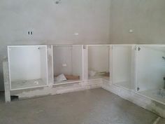 an empty room with white cabinets and no one in the room on the far wall