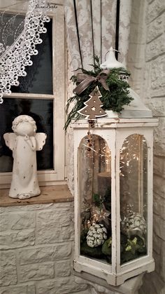 a white lantern sitting on top of a window sill