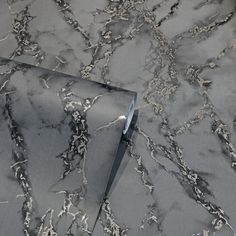 a marble table top with silver veining on the edges and an angled corner in the middle