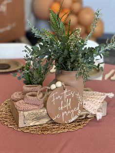 there is a potted plant on top of a table with other items around it