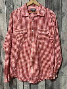 Vintage Cherokee red gingham button up shirt. Size large. 55% cotton, 45% polyester. Made  in Bangladesh. Casual Collared Gingham Shirt, Casual Gingham Cotton Flannel Shirt, Casual Gingham Collared Shirt, Fall Gingham Cotton Shirt, Classic Gingham Cotton Shirt, Classic Spring Flannel Shirt With Button Closure, Classic Flannel Shirt With Button Closure For Spring, Classic Red Flannel Shirt With Pockets, Collared Gingham Shirt For Fall