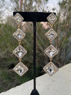 Glamorous Cubic Zirconia Chandelier Earrings For Parties, Crystal Drop Earrings For Party, Glamorous Bridal Earrings With Rhinestones, Glamorous Bridal Earrings With Diamond Accents And Crystal, Crystal Linear Drop Earrings For Parties, Glamorous Wedding Crystal Earrings, Glamorous Crystal Dangle Bridal Earrings, Glamorous Crystal Clip-on Earrings For Formal Occasions, Glamorous Crystal Linear Earrings For Party