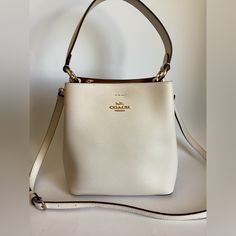 Coach Small Town Bucket Bag Leather Crossbody 1011 In Chalk White $350. Polished Pebble Leather Center Zip Compartment Snap Closure Handle With 6 3/4″ Drop Detachable Strap With 22″ Drop For Shoulder Or Crossbody Wear 8 1/2″ (L) X 8 3/4″ (H) X 4″ (W) Classic Bucket Bag With Gold-tone Hardware For Formal Occasions, Classic Formal Bucket Bag With Gold-tone Hardware, High-end Cream Bags With Detachable Handle, Timeless Formal Crossbody Bucket Bag, Classic Cream Bucket Bag With Gold-tone Hardware, Classic Cream Bag For Everyday Luxury, Elegant Satchel Bucket Bag With Detachable Strap, Elegant Formal Bucket Bag With Gold-tone Hardware, Classic Cream Bucket Bag