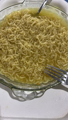 a bowl filled with noodles on top of a table