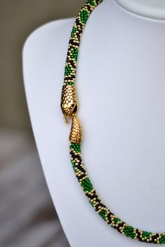 "Green gold snake serpent necklace beaded python animal long lariat transformer neckpiece hippie jewelry Length: 16 inches (40 cm) 18 inches (45 cm) 20 inches (50 cm) 25 inches (63 cm) 30 inches (75 cm) 35 inches (88 cm) 40 inches (100 cm) Matching earrings https://www.etsy.com/listing/473229526 ❤ CUSTOM ORDERS It is ABSOLUTELY HANDMADE . So if you like this item in a different color or size, send me a message please. I will send you a link for a \"custom order\" and you'll be able to place the Serpent Necklace, Green Snake, Snake Necklace, Hippie Jewelry, Gold Snake, Necklace Beaded, Green Gold, Matching Earrings, Python