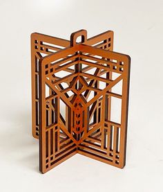 an intricate wooden object on a white surface