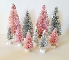 small pink and silver christmas trees are lined up