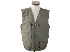 "This khaki green hunting vest has a collarless V neckline and zips closed in front. The lightweight vest features eight pockets on the front and is lined in a green cotton-polyester blend fabric (with three inner pockets). Condition: Excellent (Professionally Cleaned ... soft and supple, with no stains, tears, wear spots, or weaknesses in the seams)  Size: 40 US/UK Brand label: X-Tuxer Adventure Material: 35% cotton, 65% polyester --- M E A S U R E M E N T S --- Chest = 42 inches (106.68cm) (you want a little extra space here for what you wear under; so this is a best fit for a man with a 40\" chest) Vest Length = 25 inches (63.5cm)" Khaki Military Vest With Pockets, Khaki Military Vest With Side Pockets, Casual Hunting Vest With Pockets, Khaki Hunting Vest With Pockets, Khaki Hiking Vest With Side Pockets, Military Vest With Pockets For Hunting, Military Hunting Vest With Pockets, Hunting Vest Outerwear Sleeveless, Utility Sleeveless Hunting Vest