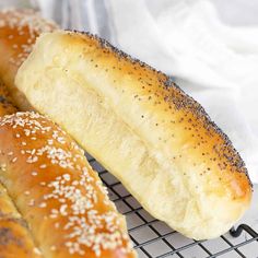 two sesame seed bagels on a cooling rack